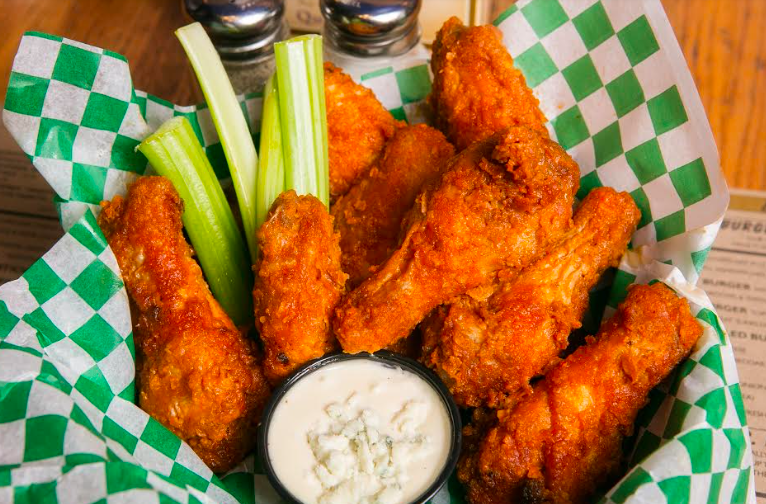 Jonas Brothers Enjoying Chicken Wings and Football at Jake Melnick’s Corner Tap